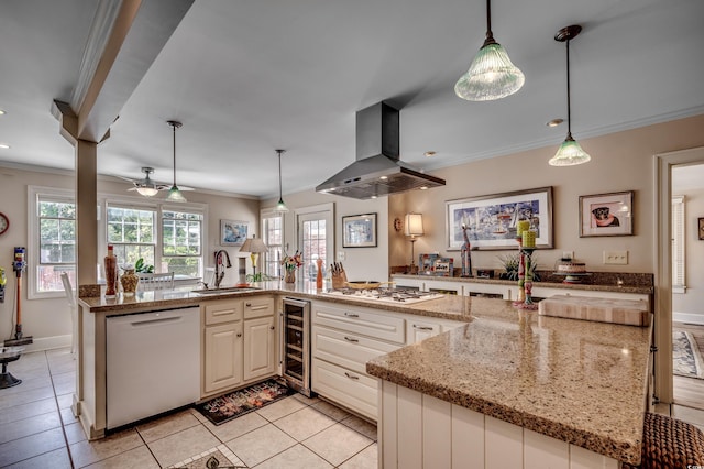 kitchen with island range hood, crown molding, a sink, wine cooler, and white appliances