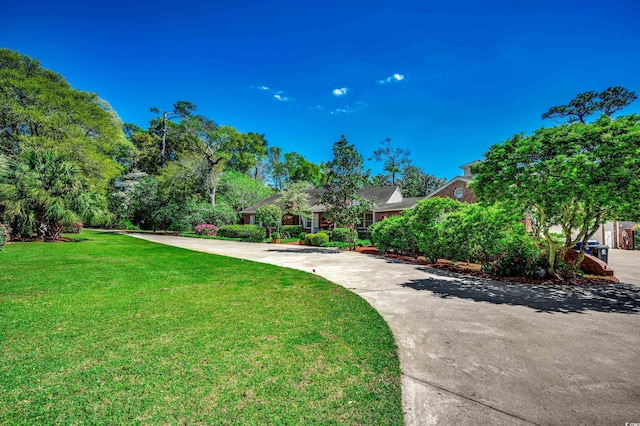 surrounding community with a lawn and driveway