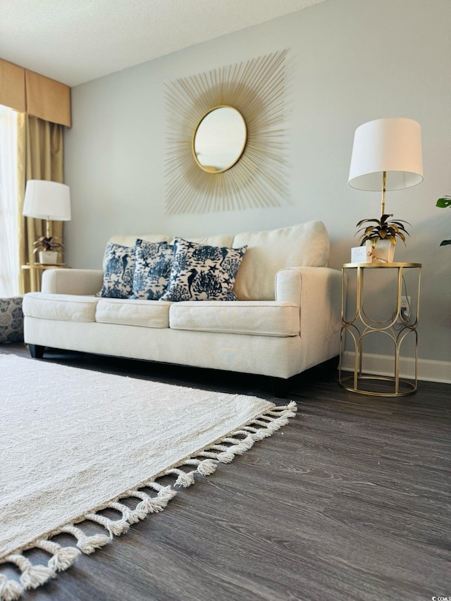 living room with baseboards and dark wood finished floors