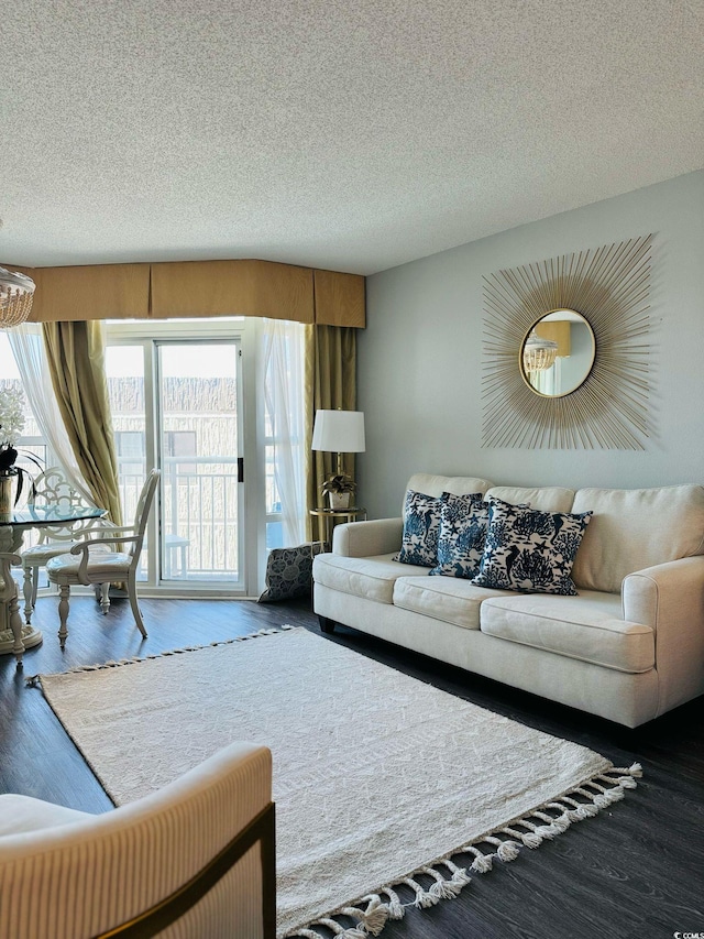 living area with a textured ceiling and wood finished floors