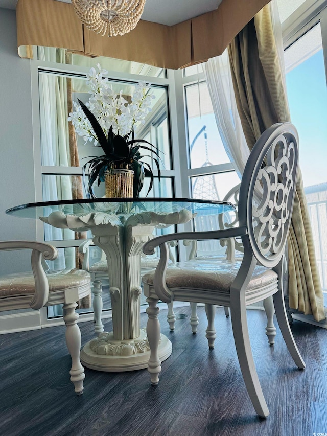 dining space featuring a notable chandelier and wood finished floors