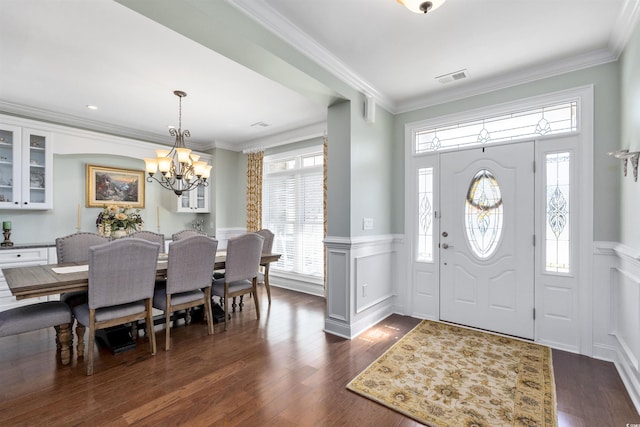 63 Grey Moss Rd, Murrells Inlet, SC 29576 - entryway with wainscoting, a chandelier, dark wood-style flooring, crown molding, and a decorative wall