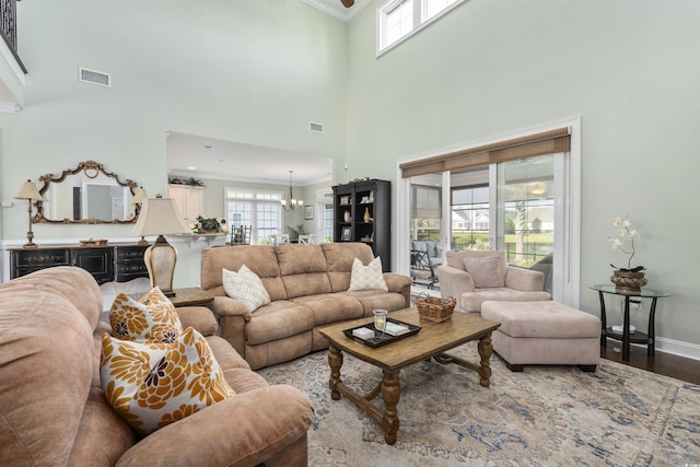 63 Grey Moss Rd, Murrells Inlet, SC 29576 - living room featuring a chandelier, crown molding, plenty of natural light, wood finished floors, and baseboards