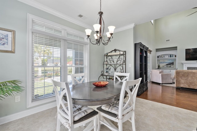 63 Grey Moss Rd, Murrells Inlet, SC 29576 - dining space featuring a chandelier, crown molding, tile patterned floors, baseboards, and a fireplace
