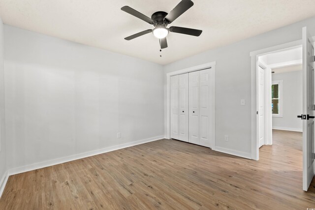 421 Villa Woods Dr, Myrtle Beach, SC 29579 - unfurnished bedroom with baseboards, a ceiling fan, wood finished floors, and a closet