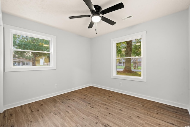 421 Villa Woods Dr, Myrtle Beach, SC 29579 - spare room featuring visible vents, baseboards, wood finished floors, and a healthy amount of sunlight