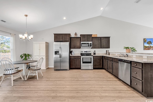 122 Desurrency Ct, Georgetown, SC 29440 - kitchen featuring dark brown cabinets, light wood-style flooring, appliances with stainless steel finishes, a notable chandelier, and vaulted ceiling