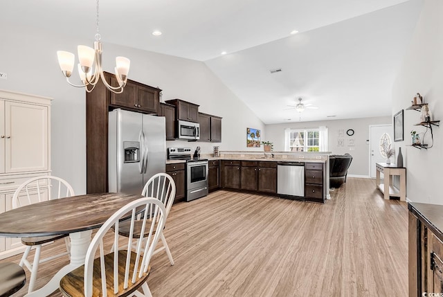 122 Desurrency Ct, Georgetown, SC 29440 - kitchen featuring light wood-style floors, appliances with stainless steel finishes, dark brown cabinetry, and vaulted ceiling