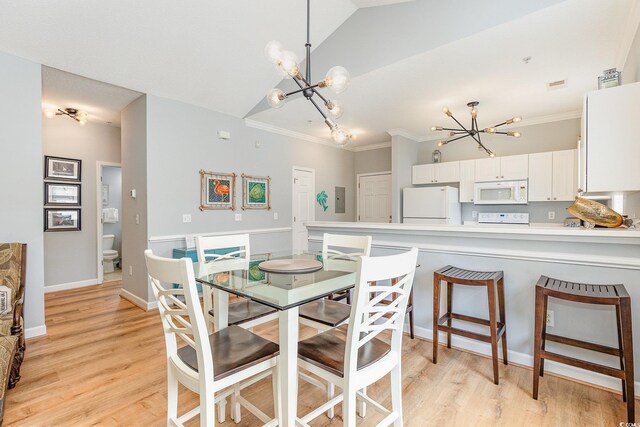 6253 Catalina Dr Unit 131, North Myrtle Beach, SC 29582 - dining space with baseboards, ornamental molding, a notable chandelier, and light wood-style flooring