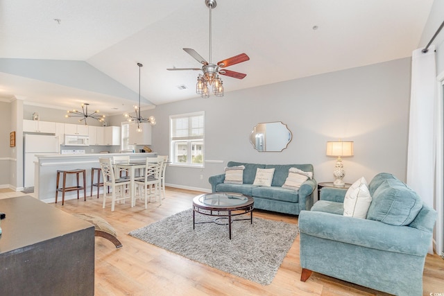 6253 Catalina Dr Unit 131, North Myrtle Beach, SC 29582 - living room with light wood-type flooring, visible vents, vaulted ceiling, baseboards, and ceiling fan with notable chandelier