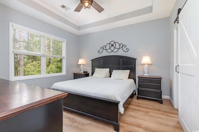 6253 Catalina Dr Unit 131, North Myrtle Beach, SC 29582 - bedroom with ornamental molding, visible vents, light wood finished floors, and a barn door