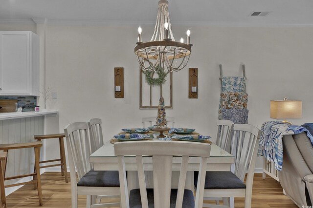 601 Hillside Dr N Unit 1405, North Myrtle Beach, SC 29582 - dining room featuring crown molding, visible vents, an inviting chandelier, and light wood-type flooring