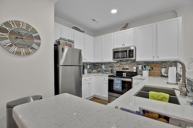 601 Hillside Dr N Unit 1405, North Myrtle Beach, SC 29582 - kitchen with white cabinets, light stone countertops, a sink, stainless steel appliances, and visible vents