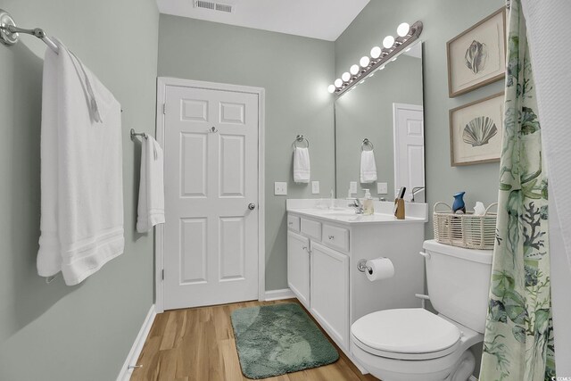 601 Hillside Dr N Unit 1405, North Myrtle Beach, SC 29582 - bathroom featuring visible vents, wood finished floors, vanity, baseboards, and toilet