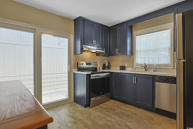 401 77th Ave N Unit 11, Myrtle Beach, SC 29572 - kitchen with appliances with stainless steel finishes, under cabinet range hood, healthy amount of natural light, and light countertops