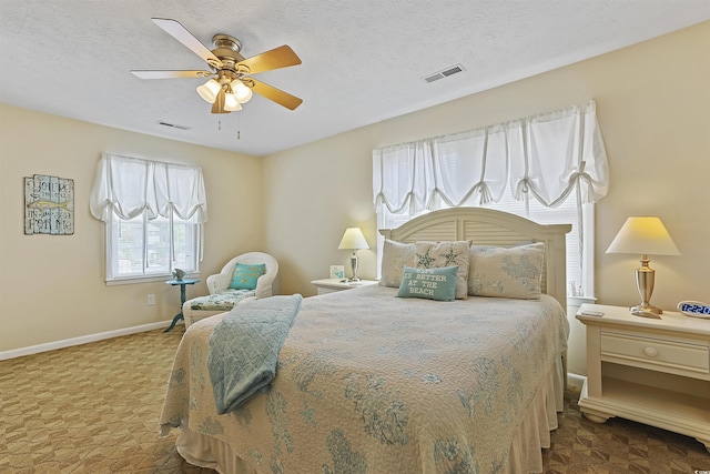 401 77th Ave N Unit 11, Myrtle Beach, SC 29572 - bedroom featuring ceiling fan, baseboards, carpet, and a textured ceiling