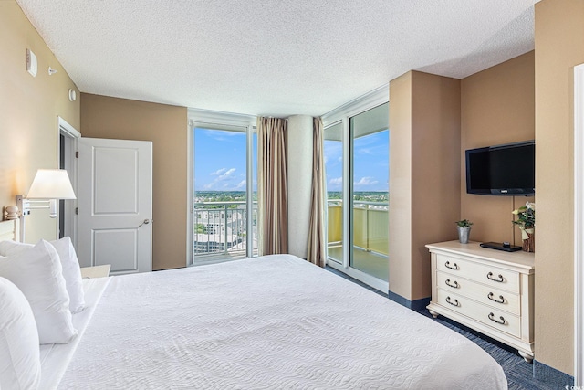 bedroom featuring access to outside and a textured ceiling