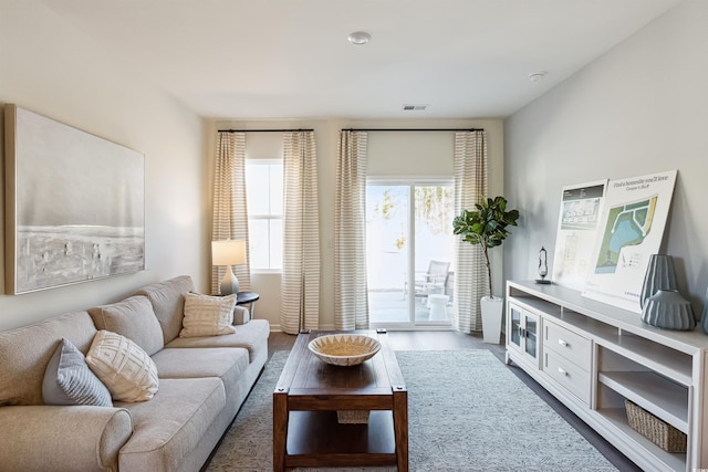 living room featuring visible vents and wood finished floors