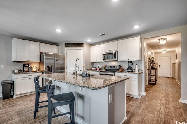 777 Woodland Farms Cir, Aynor, SC 29511 - kitchen featuring appliances with stainless steel finishes, visible vents, light wood finished floors, and a sink