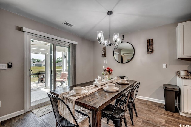 777 Woodland Farms Cir, Aynor, SC 29511 - dining room with baseboards, visible vents, wood finished floors, and an inviting chandelier