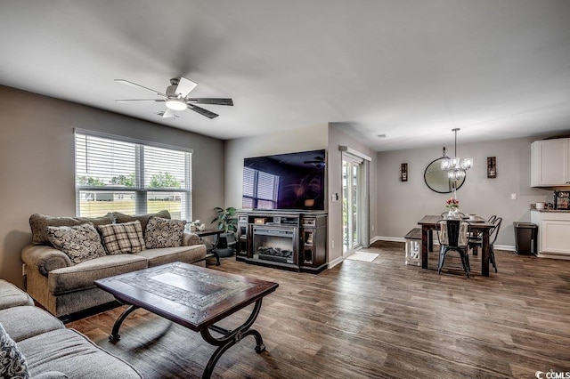 777 Woodland Farms Cir, Aynor, SC 29511 - living area with a fireplace, dark wood-style flooring, baseboards, and ceiling fan with notable chandelier
