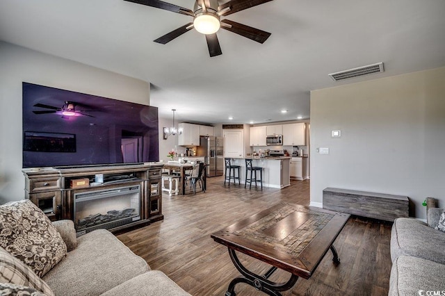777 Woodland Farms Cir, Aynor, SC 29511 - living area with dark wood-type flooring, visible vents, recessed lighting, and ceiling fan with notable chandelier