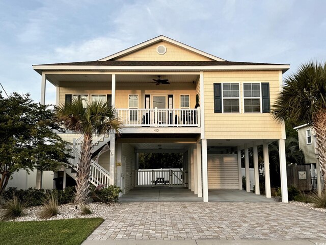 412 29th Ave N, North Myrtle Beach, SC 29582 - beach home featuring fence, stairway, ceiling fan, a carport, and decorative driveway