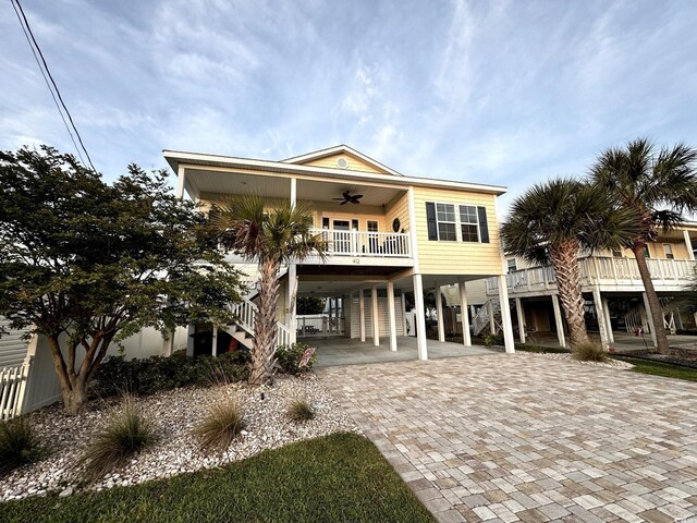 412 29th Ave N, North Myrtle Beach, SC 29582 - view of front of property with covered porch, a carport, decorative driveway, ceiling fan, and stairs