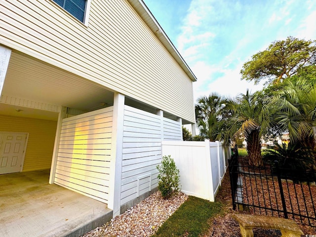 view of side of home featuring fence