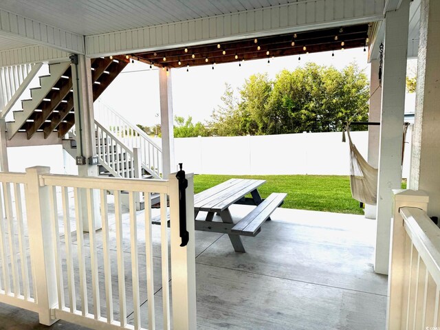 412 29th Ave N, North Myrtle Beach, SC 29582 - view of patio with stairway, a fenced backyard, and outdoor dining area