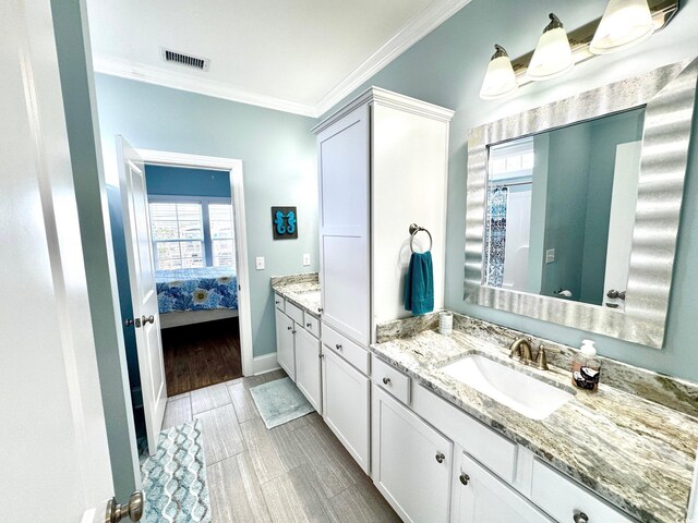 412 29th Ave N, North Myrtle Beach, SC 29582 - full bathroom with ensuite bathroom, vanity, ornamental molding, visible vents, and baseboards