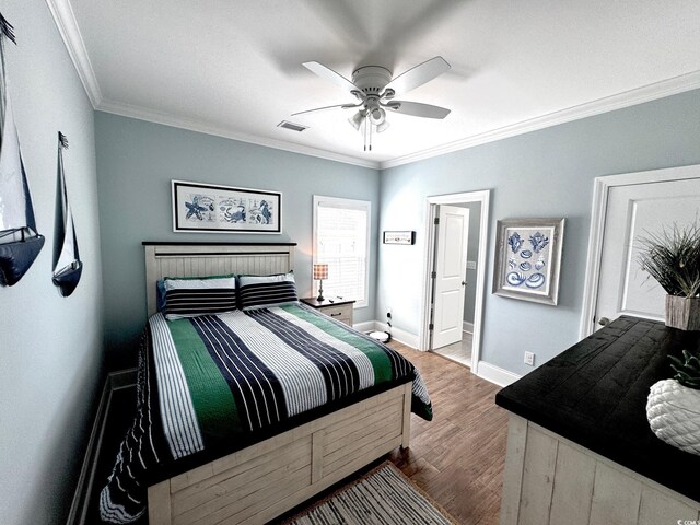 412 29th Ave N, North Myrtle Beach, SC 29582 - bedroom featuring a ceiling fan, baseboards, ornamental molding, visible vents, and wood finished floors