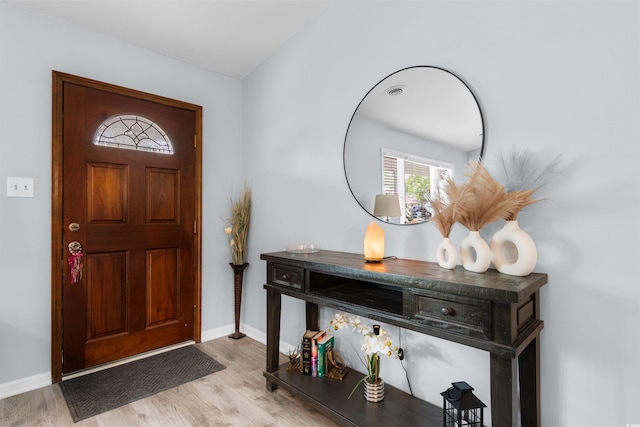 entrance foyer with baseboards and wood finished floors