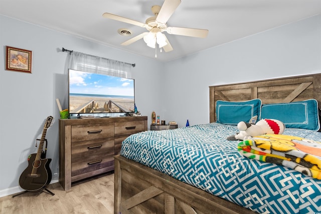 bedroom with light wood-style floors, baseboards, ceiling fan, and visible vents