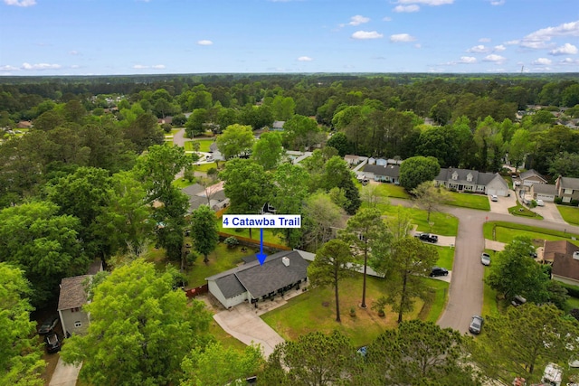 bird's eye view with a wooded view and a residential view