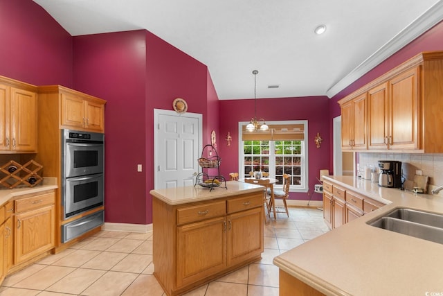 kitchen with a kitchen island, a warming drawer, double oven, a sink, and backsplash