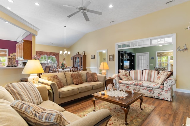 living area featuring ceiling fan with notable chandelier, recessed lighting, wood finished floors, and a wealth of natural light