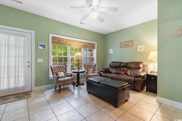 living room with light tile patterned floors, baseboards, ceiling fan, and visible vents