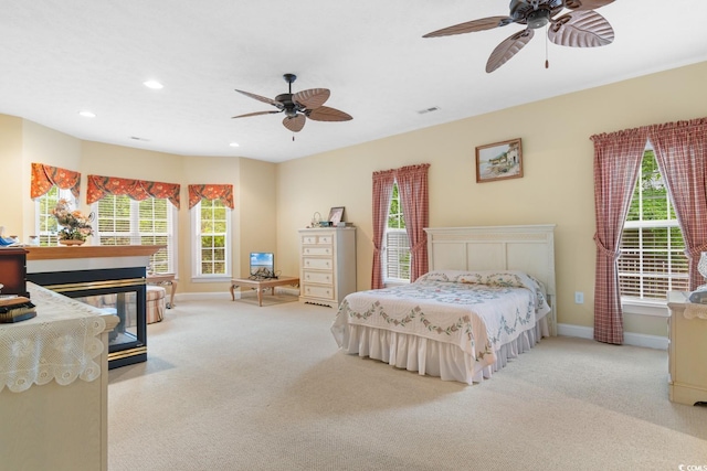 bedroom featuring carpet floors, multiple windows, and baseboards