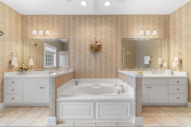full bath featuring tile patterned floors, wallpapered walls, a sink, and a garden tub