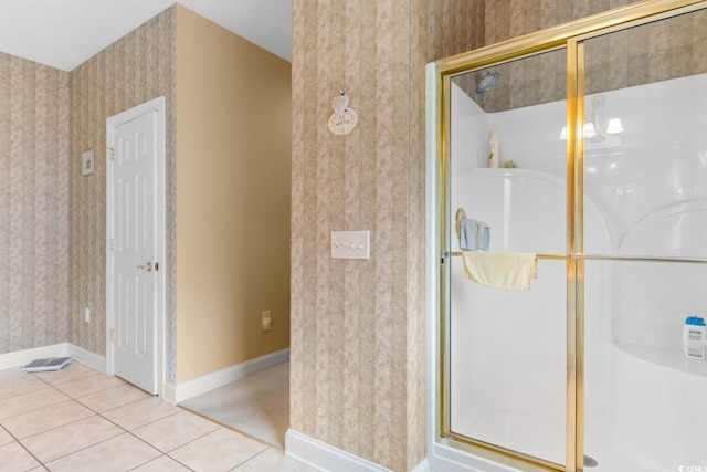 full bath featuring tile patterned floors, baseboards, a shower stall, and wallpapered walls