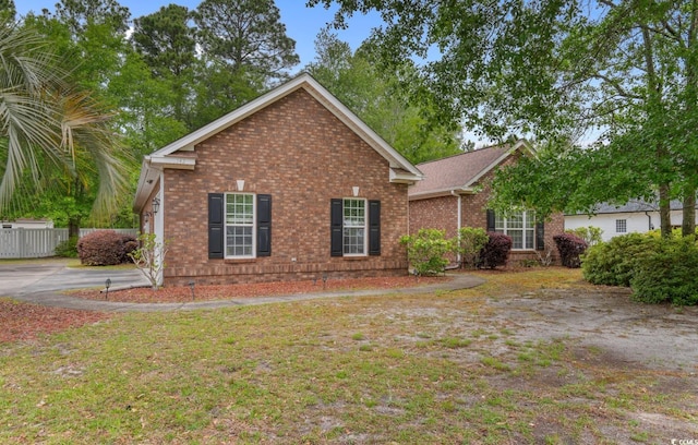 view of front of property with brick siding and fence