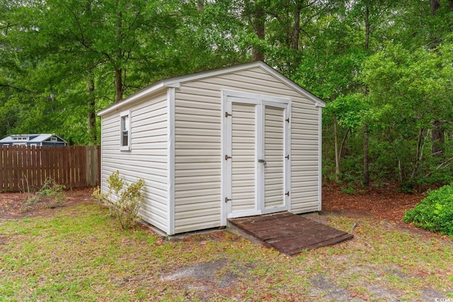 view of shed featuring fence