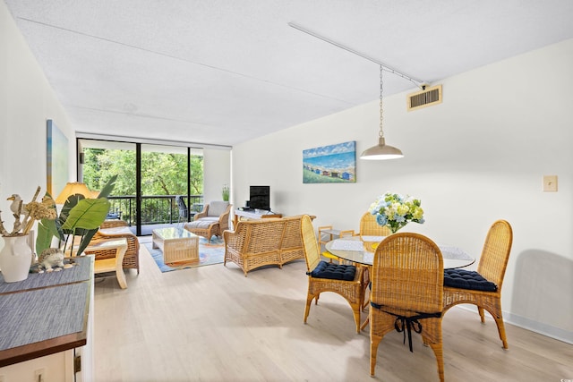 311 71st Ave N Unit 3-D, Myrtle Beach, SC 29572 - dining area featuring light wood finished floors, expansive windows, and visible vents