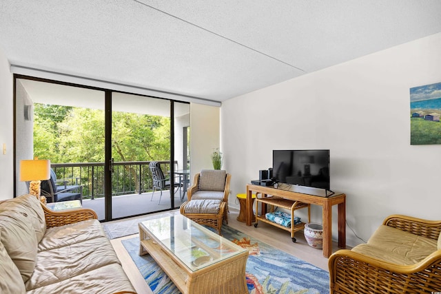 311 71st Ave N Unit 3-D, Myrtle Beach, SC 29572 - living area with a wall of windows, a textured ceiling, and wood finished floors