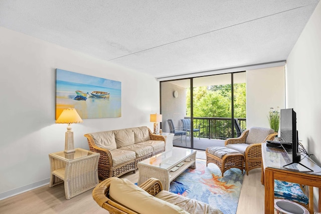 311 71st Ave N Unit 3-D, Myrtle Beach, SC 29572 - living area featuring baseboards, a textured ceiling, floor to ceiling windows, and wood finished floors