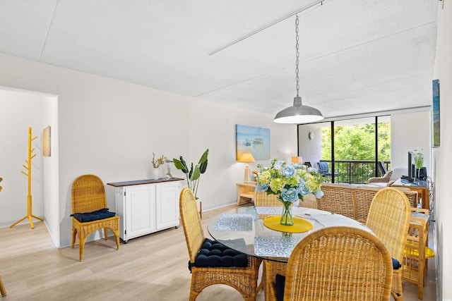311 71st Ave N Unit 3-D, Myrtle Beach, SC 29572 - dining room featuring baseboards and light wood-style flooring
