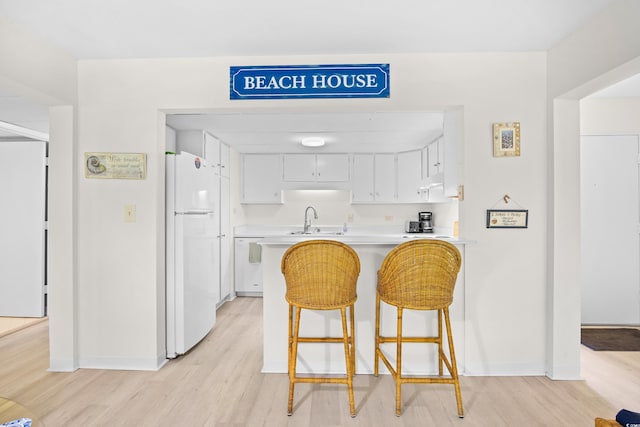 311 71st Ave N Unit 3-D, Myrtle Beach, SC 29572 - kitchen featuring light wood-style floors, a sink, white appliances, and light countertops