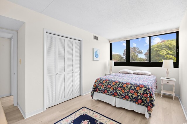 311 71st Ave N Unit 3-D, Myrtle Beach, SC 29572 - bedroom with a closet, visible vents, multiple windows, and light wood-type flooring