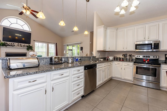 133 Alpharetta Ct, Conway, SC 29526 - kitchen with appliances with stainless steel finishes, a sink, light tile patterned floors, lofted ceiling, and white cabinetry
